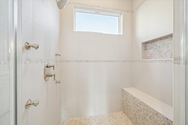 bathroom with a tile shower