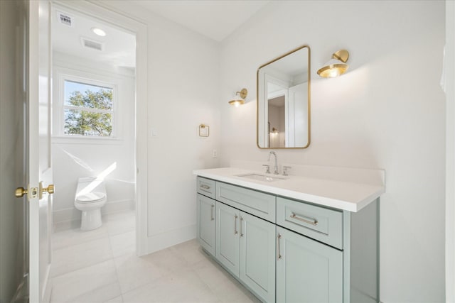 bathroom featuring tile patterned flooring, a soaking tub, visible vents, and vanity