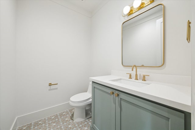 half bath featuring toilet, vanity, and baseboards