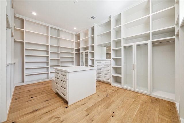 spacious closet featuring light hardwood / wood-style flooring