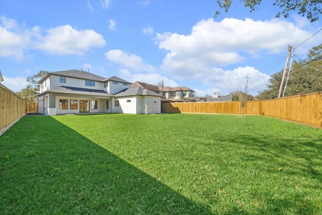 view of yard with a fenced backyard