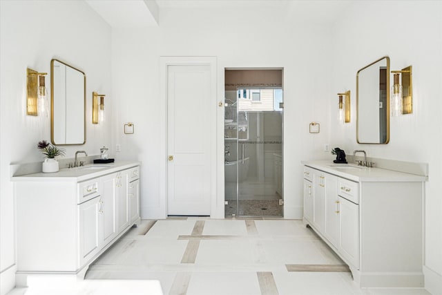 full bathroom featuring two vanities, a sink, and baseboards