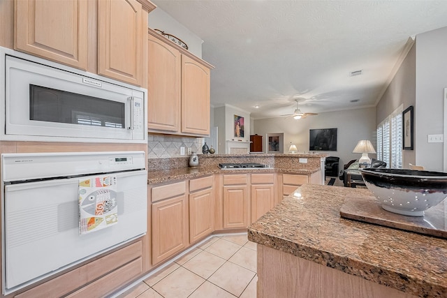 kitchen featuring tasteful backsplash, light tile patterned floors, white oven, ceiling fan, and light brown cabinets