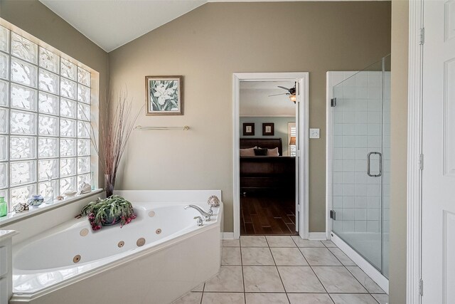 bathroom with ceiling fan, shower with separate bathtub, lofted ceiling, and tile patterned flooring