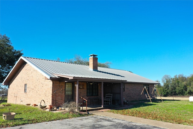 view of front of house with a front yard and a porch