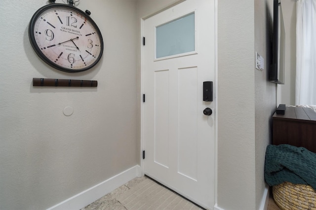 entryway with light tile patterned floors