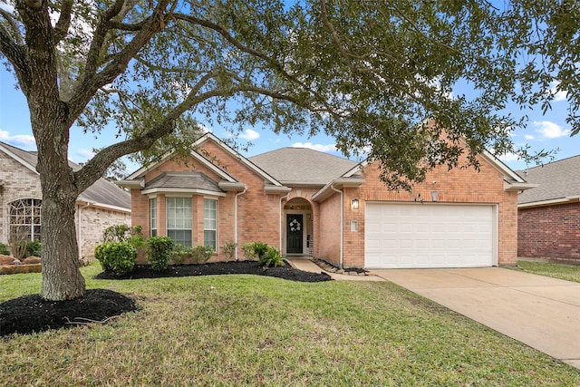 view of front of property with a garage and a front lawn