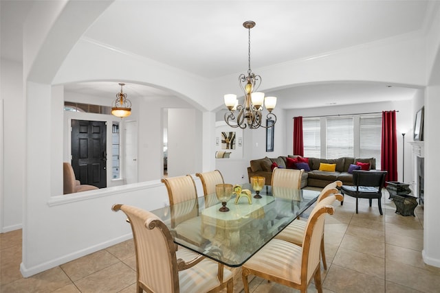 tiled dining space with an inviting chandelier and crown molding