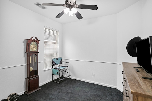 interior space featuring ceiling fan and dark colored carpet