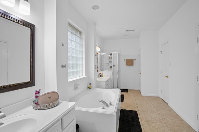 bathroom featuring tile patterned floors, vanity, and shower with separate bathtub