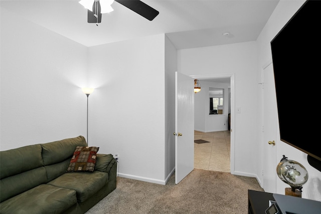 living room featuring light colored carpet and ceiling fan