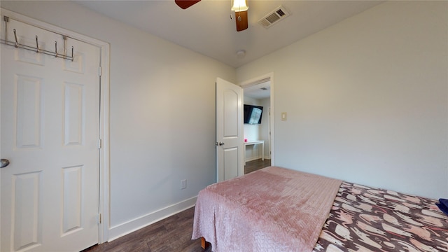 bedroom featuring ceiling fan and dark hardwood / wood-style floors