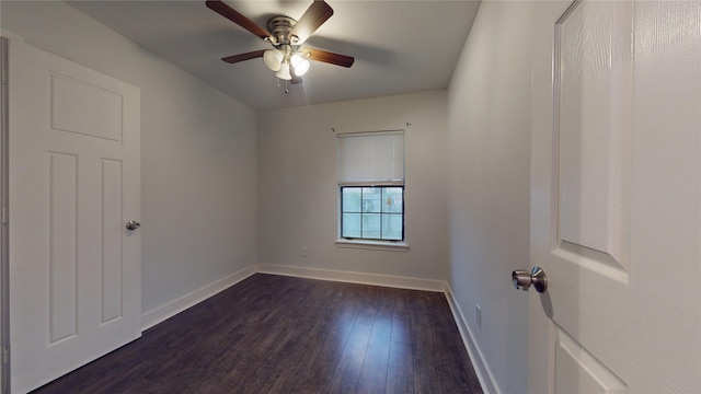 empty room featuring ceiling fan and dark wood-type flooring