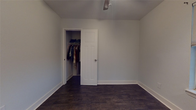 unfurnished bedroom with dark hardwood / wood-style floors, ceiling fan, and a closet