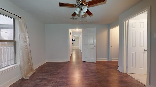 spare room with ceiling fan and dark hardwood / wood-style flooring