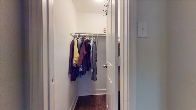 spacious closet with dark wood-type flooring