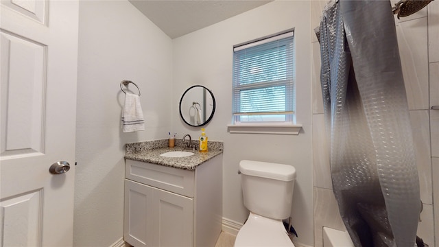 bathroom featuring vanity and toilet