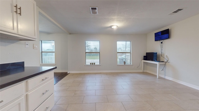 kitchen featuring white cabinetry and light tile patterned floors