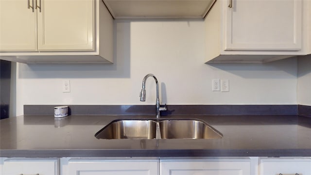 kitchen featuring sink and white cabinets