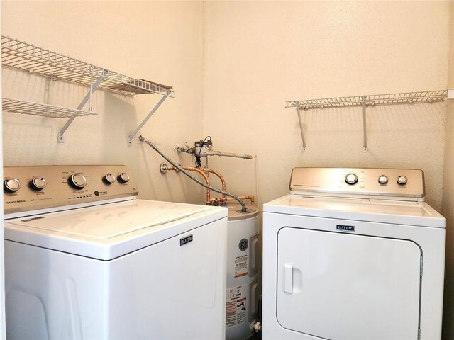 clothes washing area featuring separate washer and dryer