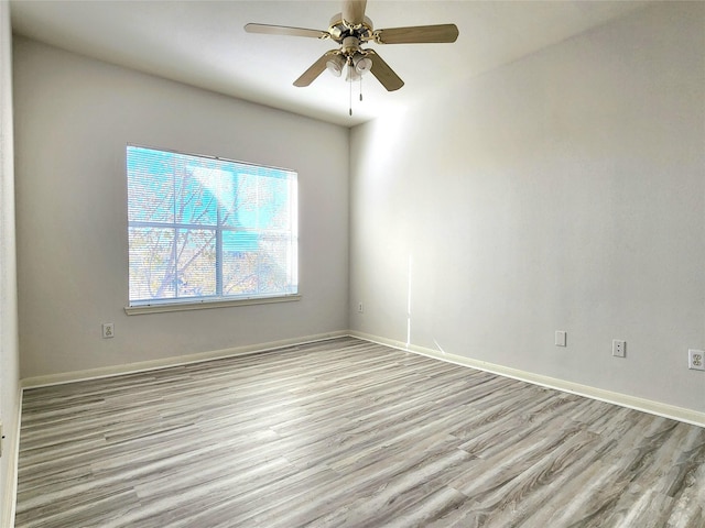 spare room with light hardwood / wood-style flooring and ceiling fan