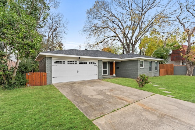 ranch-style house featuring a front yard and a garage