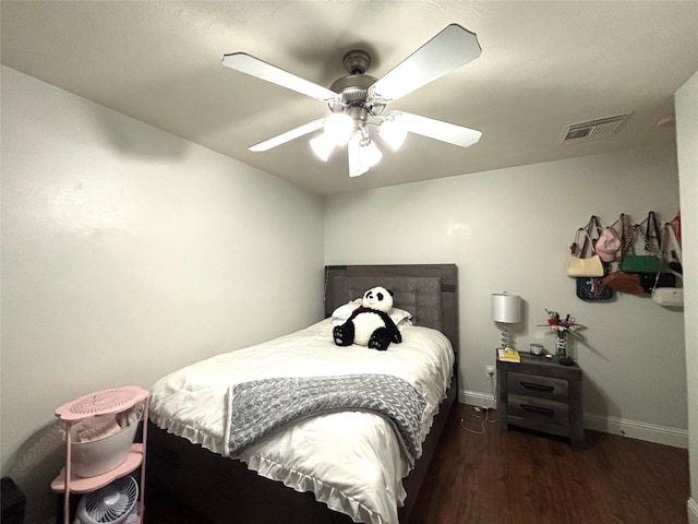 bedroom featuring ceiling fan and dark wood-type flooring