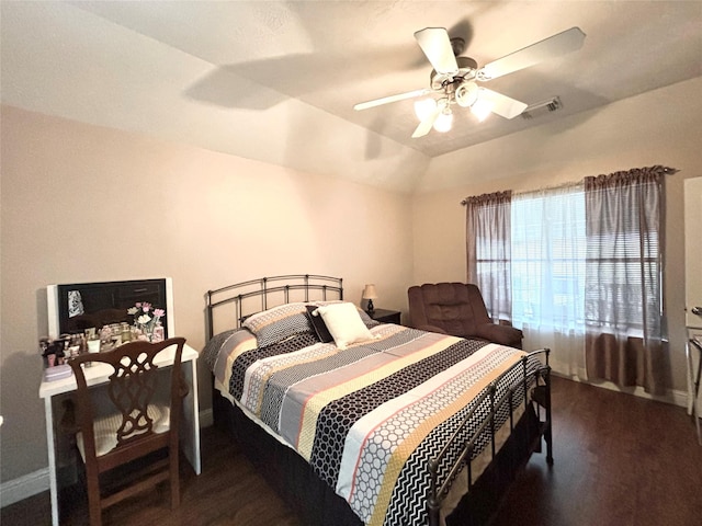 bedroom with ceiling fan, dark hardwood / wood-style flooring, and vaulted ceiling