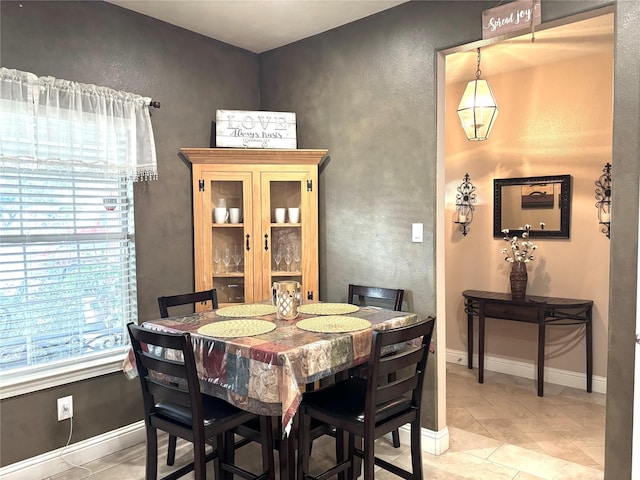 dining area featuring light tile patterned flooring