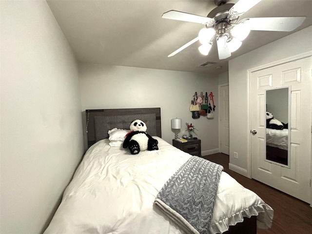 bedroom with ceiling fan and dark hardwood / wood-style floors