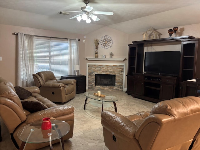 living room featuring ceiling fan, a fireplace, and vaulted ceiling