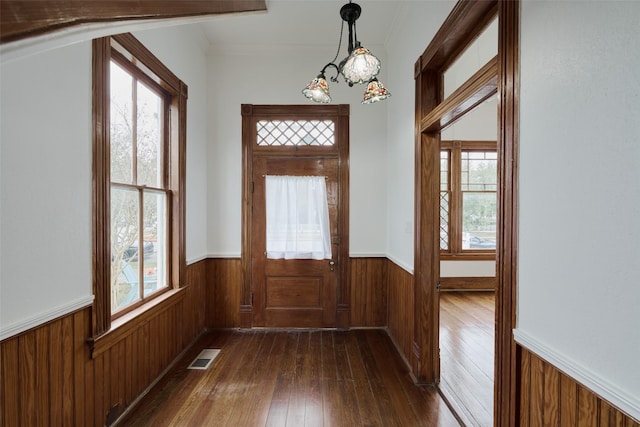 doorway to outside featuring dark wood-type flooring and plenty of natural light