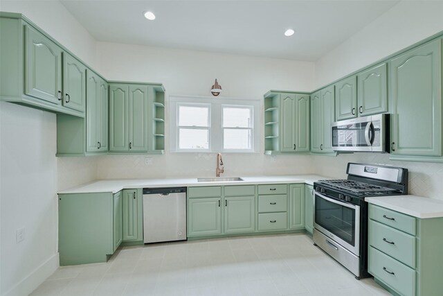 kitchen featuring green cabinetry, stainless steel appliances, tasteful backsplash, and sink