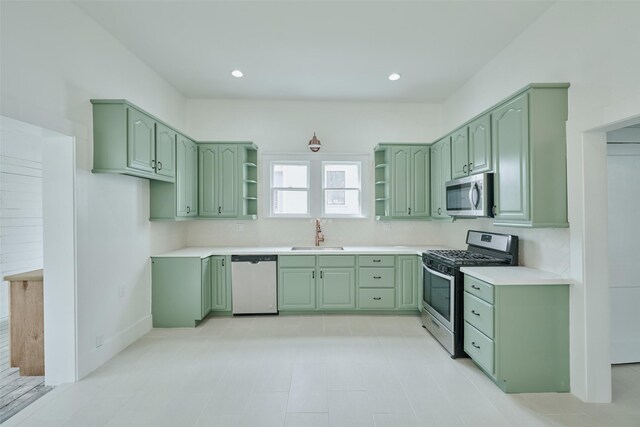 kitchen featuring sink, appliances with stainless steel finishes, and green cabinetry