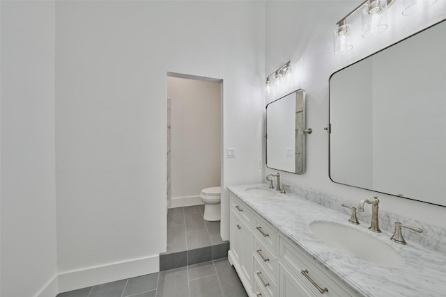 bathroom featuring toilet, tile patterned flooring, and vanity