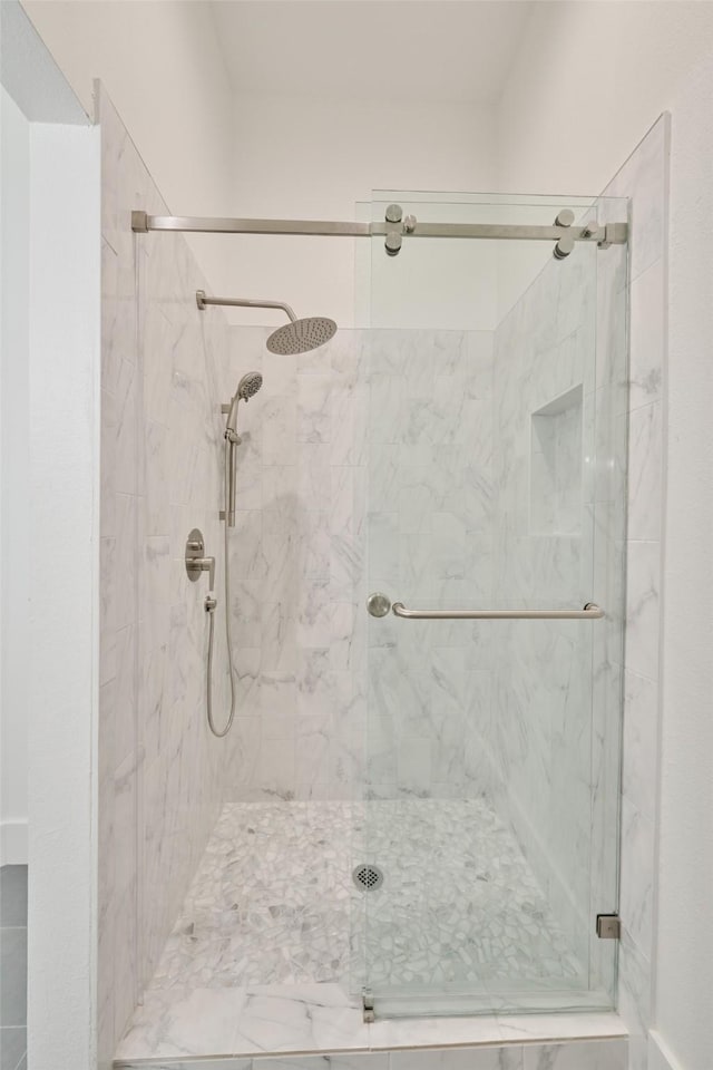 bathroom with a shower with shower door