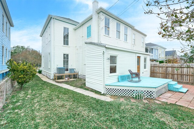 back of house with a deck, central AC, and a yard