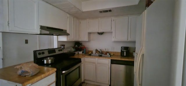 kitchen featuring white cabinetry, sink, stainless steel appliances, and ventilation hood