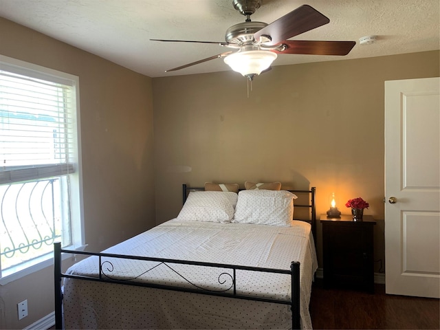 bedroom with a textured ceiling and ceiling fan