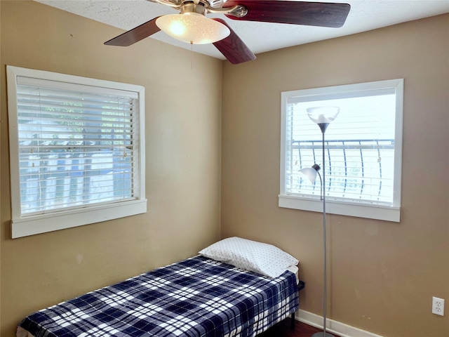 bedroom featuring baseboards and ceiling fan