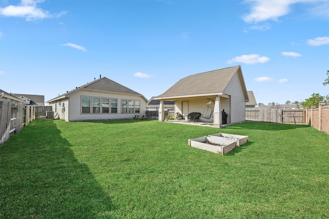 back of house featuring a yard, central AC, and a patio area