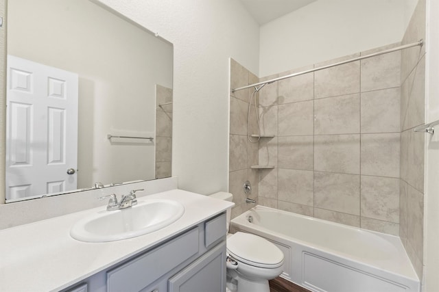 full bathroom featuring vanity, toilet, and tiled shower / bath