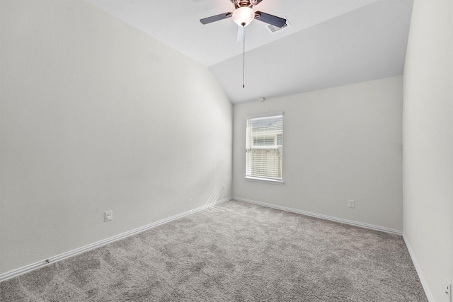 carpeted spare room featuring ceiling fan and lofted ceiling