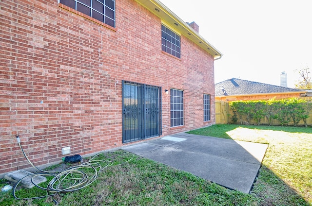 rear view of house featuring a patio area and a lawn