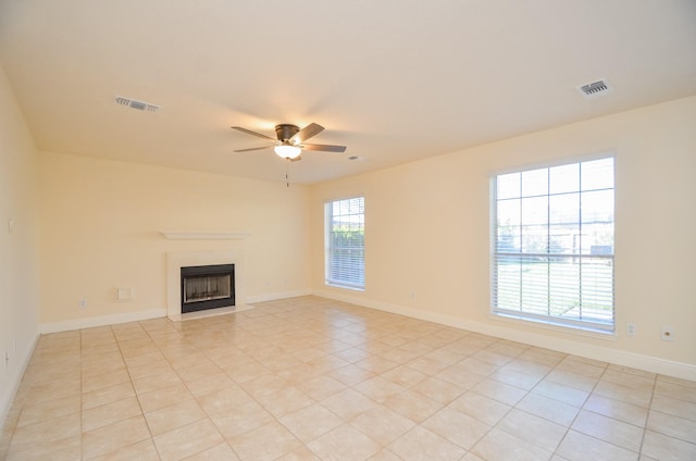 unfurnished living room with ceiling fan and light tile patterned floors