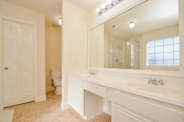 bathroom featuring tile patterned floors, vanity, toilet, and a shower with shower door