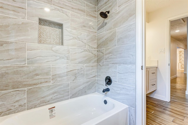 bathroom featuring vanity and tiled shower / bath combo