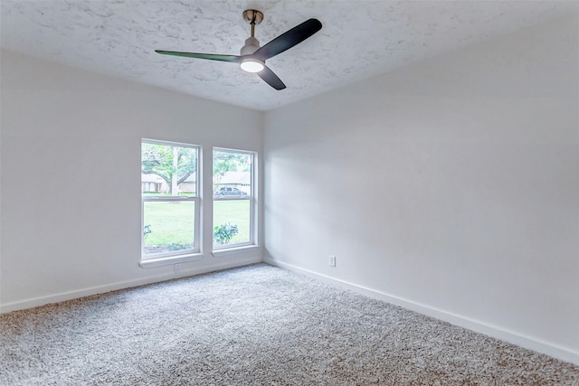 carpeted spare room featuring a textured ceiling and ceiling fan