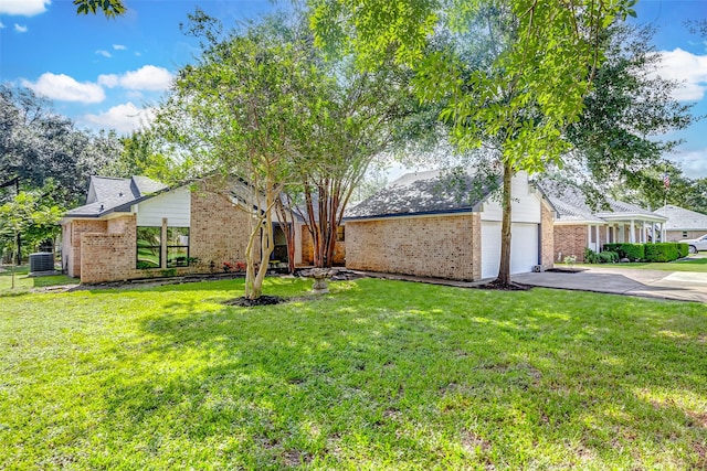 view of front of house with central AC, a front lawn, and a garage