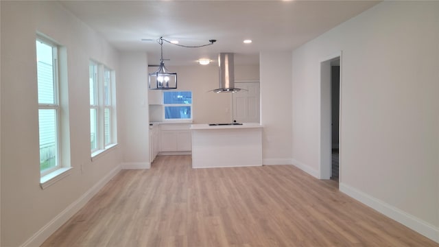 interior space featuring light hardwood / wood-style flooring, a wealth of natural light, and a notable chandelier